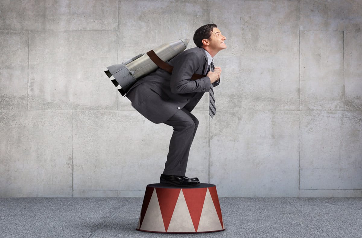 developing yourself: executive coaching. image of a man with a rocket strapped to his back