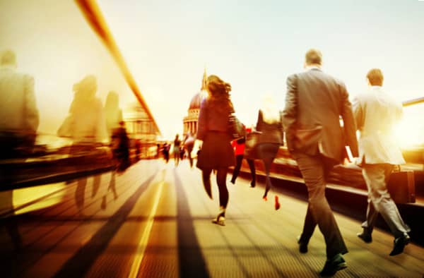 Image of commuting professionals crossing a city bridge - working with professional and financial services sectors
