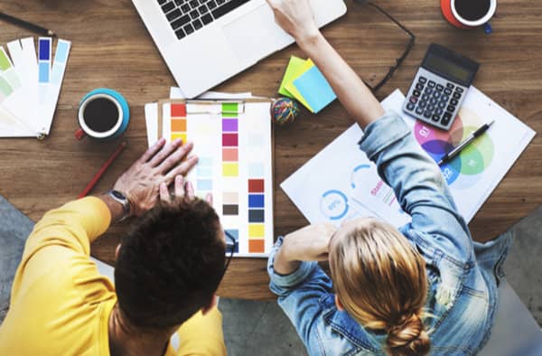 image of creative people around a desk - retail and creative industries sector