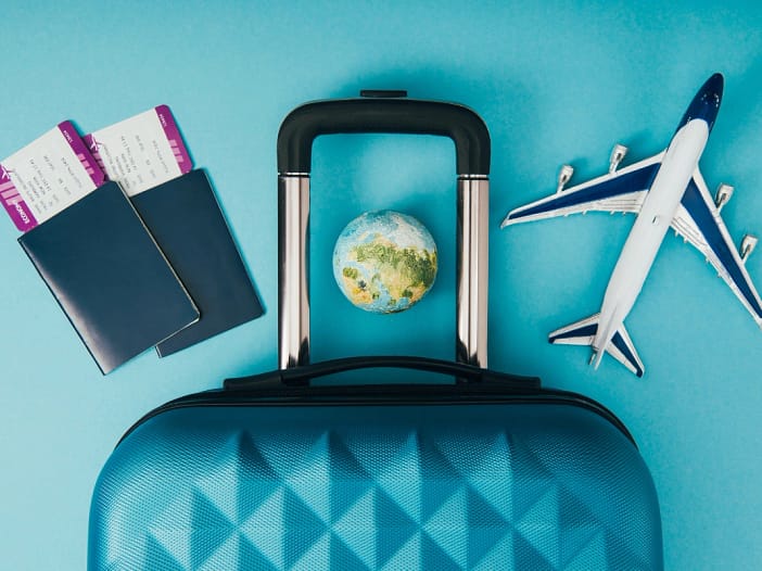 Executive assistant - image of suitcase with aircraft and plane tickets