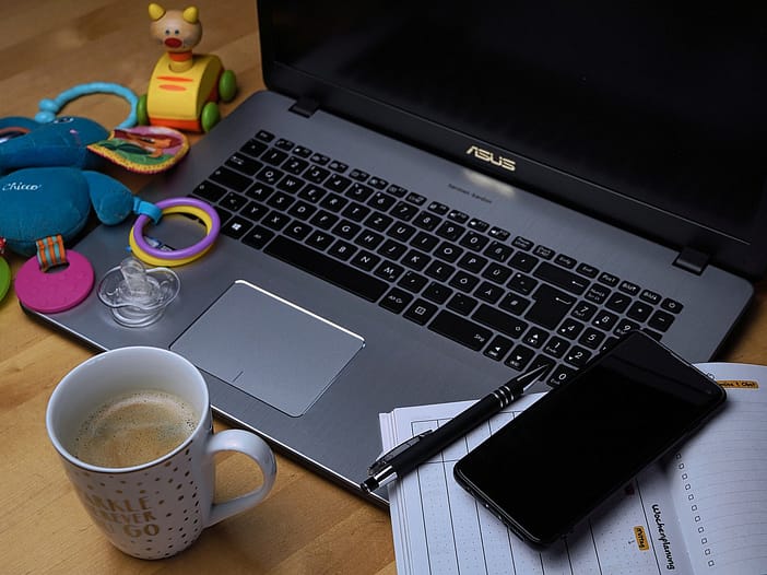 work life balance - image of a computer surrounded by home objects and toys